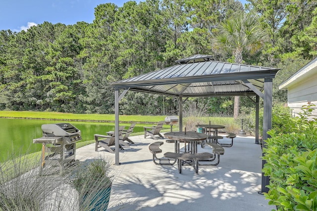 view of patio / terrace featuring a gazebo, a water view, and area for grilling