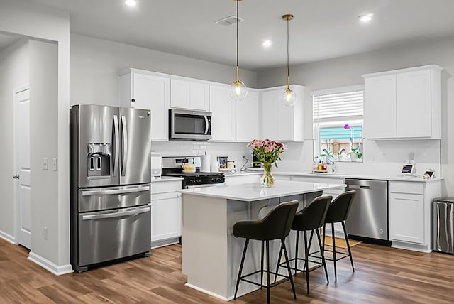513 Donnas View Way, Summerville, SC 29486 - kitchen featuring appliances with stainless steel finishes, a kitchen island, white cabinetry, dark wood-style floors, and recessed lighting