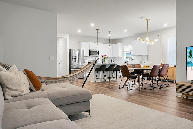 513 Donnas View Way, Summerville, SC 29486 - living area featuring light wood-style floors, a chandelier, and recessed lighting