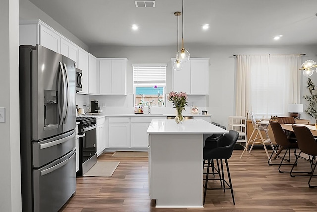 513 Donnas View Way, Summerville, SC 29486 - kitchen featuring stainless steel appliances, a kitchen breakfast bar, dark wood-type flooring, white cabinetry, and recessed lighting