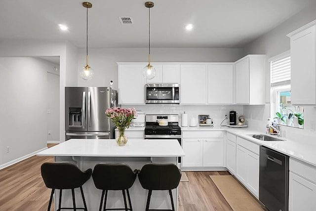 513 Donnas View Way, Summerville, SC 29486 - kitchen featuring stainless steel appliances, a sink, decorative backsplash, a breakfast bar area, and a center island