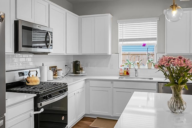 513 Donnas View Way, Summerville, SC 29486 - kitchen with appliances with stainless steel finishes, a sink, light countertops, white cabinetry, and tasteful backsplash