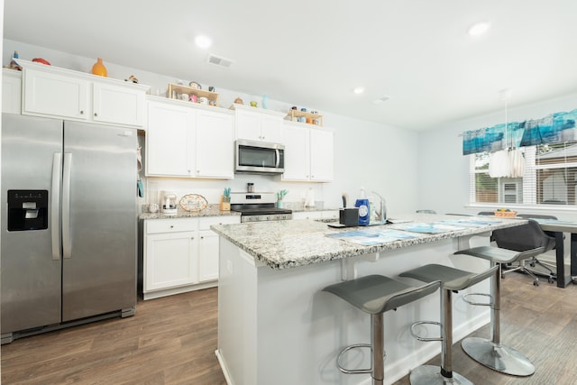 kitchen featuring dark hardwood / wood-style flooring, white cabinetry, and appliances with stainless steel finishes