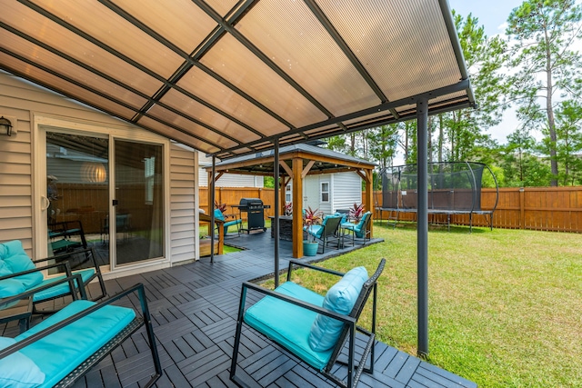 wooden deck with an outdoor living space, a gazebo, grilling area, a patio area, and a trampoline