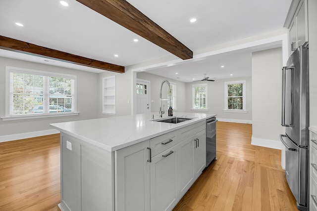 31 Lyttleton St, Charleston, SC 29407 - kitchen featuring appliances with stainless steel finishes, a sink, open floor plan, baseboards, and light wood-type flooring