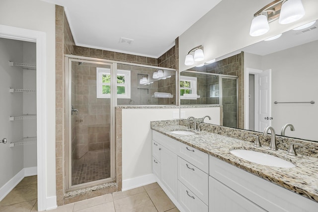31 Lyttleton St, Charleston, SC 29407 - bathroom featuring double vanity, a shower stall, a walk in closet, and tile patterned flooring