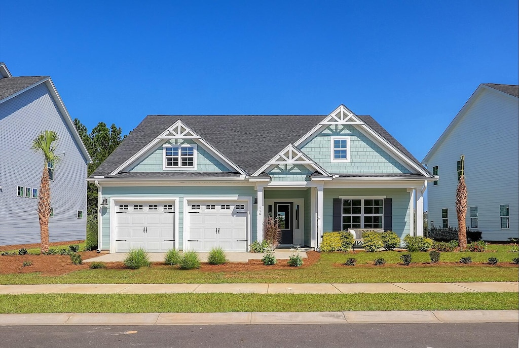 craftsman-style house with covered porch and a garage