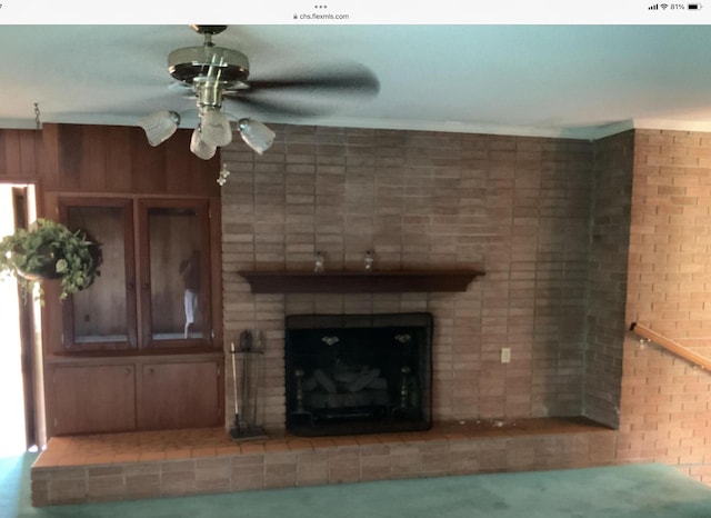 unfurnished living room with a fireplace and a ceiling fan