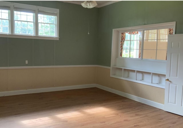 unfurnished room with baseboards and wood finished floors