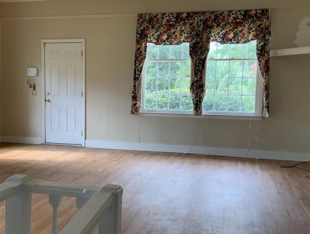 unfurnished room with wood finished floors and baseboards