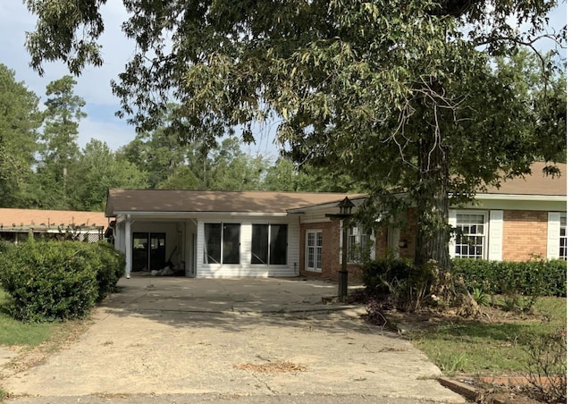 view of front of property with a carport and brick siding