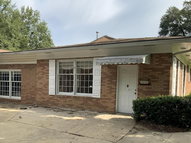 property entrance with brick siding