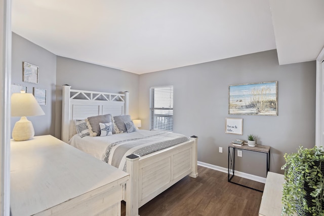bedroom featuring dark wood-style floors and baseboards