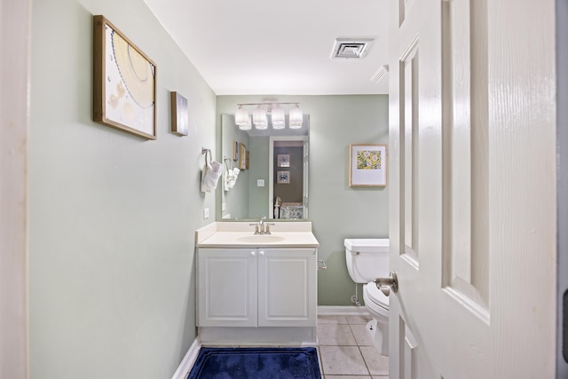 half bath featuring toilet, tile patterned flooring, vanity, and baseboards