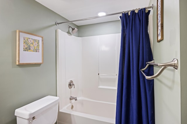 full bathroom featuring shower / bath combo with shower curtain and toilet