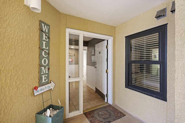 entrance to property with stucco siding