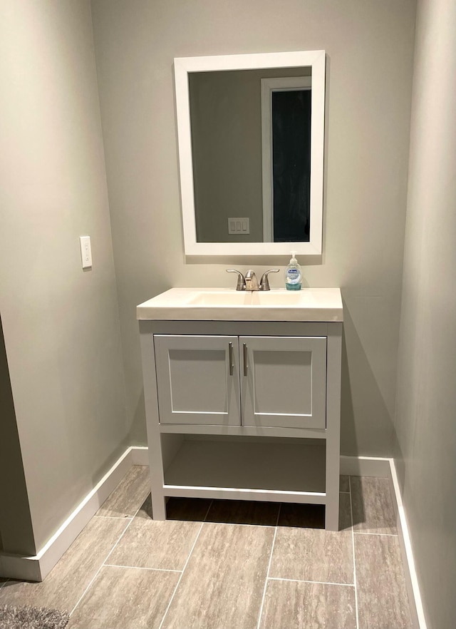 bathroom with baseboards and vanity