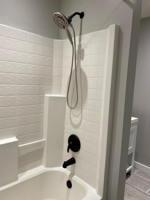 bathroom featuring baseboards and shower / bathing tub combination