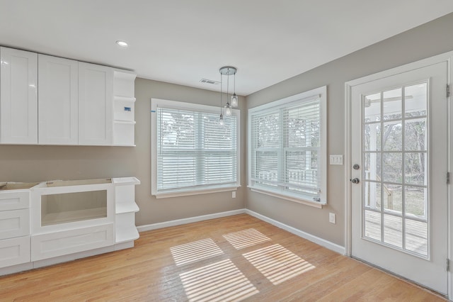 unfurnished dining area with recessed lighting, visible vents, baseboards, and light wood-style floors