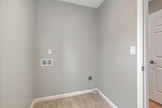 laundry room with laundry area, hookup for a washing machine, electric dryer hookup, and baseboards