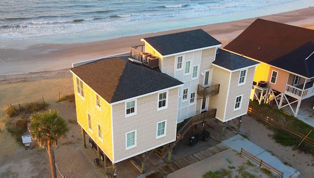 bird's eye view featuring a water view and a beach view