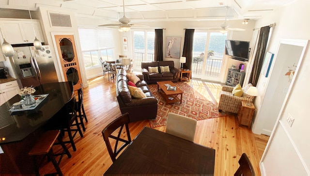 living room featuring ceiling fan and light hardwood / wood-style flooring