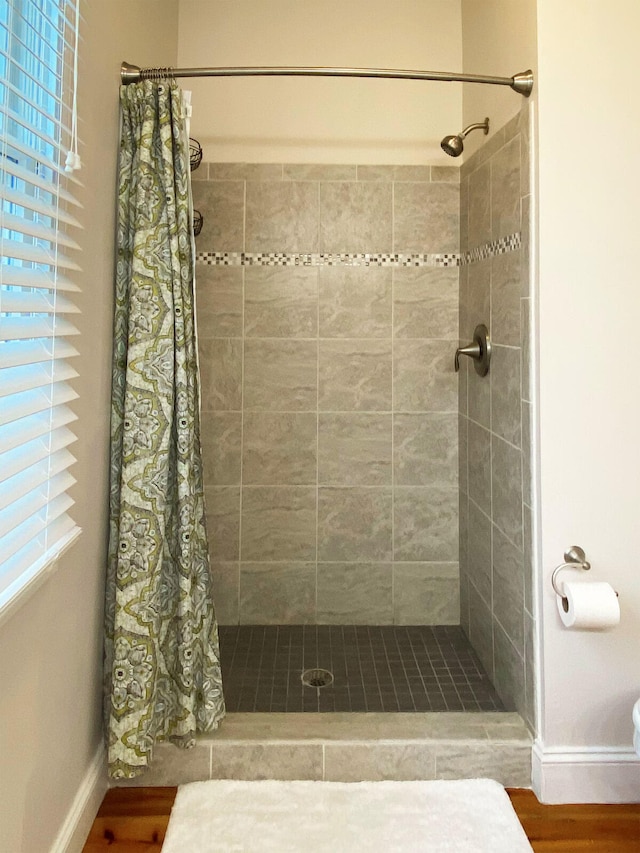 bathroom featuring a shower with curtain and hardwood / wood-style flooring