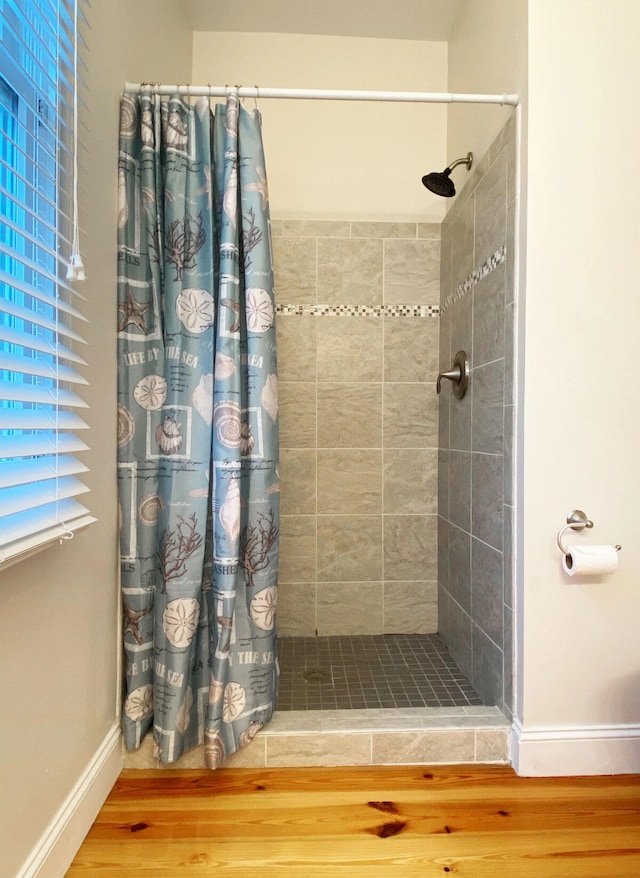 bathroom featuring hardwood / wood-style floors and a shower with shower curtain