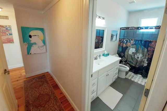 bathroom featuring a shower with shower curtain, vanity, hardwood / wood-style flooring, and toilet