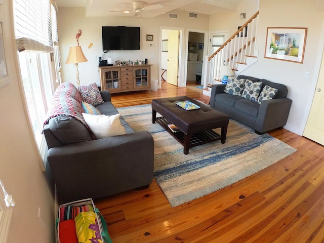 living room featuring ceiling fan and hardwood / wood-style floors