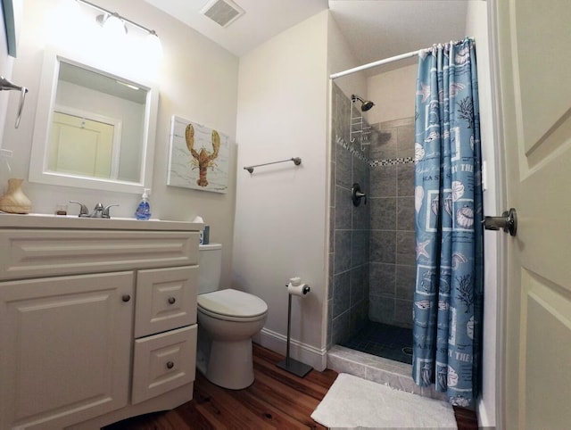 bathroom with hardwood / wood-style flooring, vanity, toilet, and a shower with shower curtain