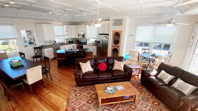 living room featuring hardwood / wood-style floors and ceiling fan