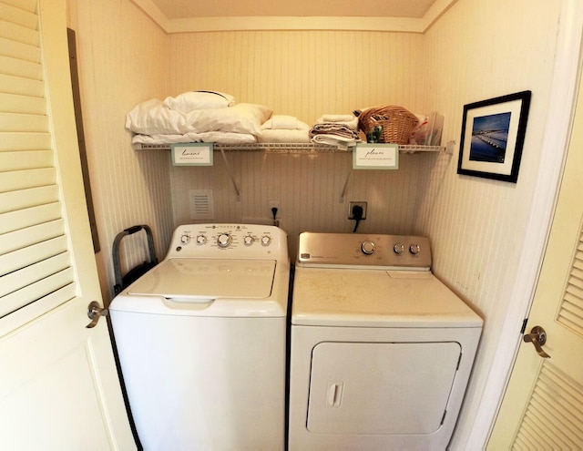 laundry area featuring washing machine and clothes dryer