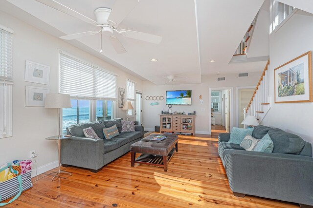 living room with light wood-type flooring and ceiling fan