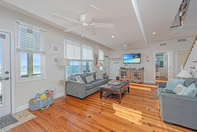 living room featuring ceiling fan, a healthy amount of sunlight, and light hardwood / wood-style flooring