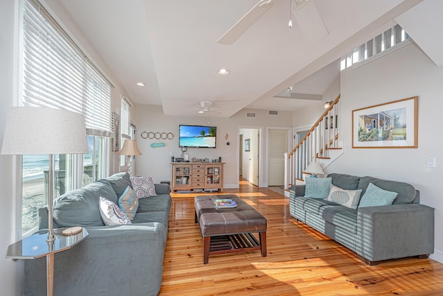 living room with ceiling fan and light hardwood / wood-style flooring