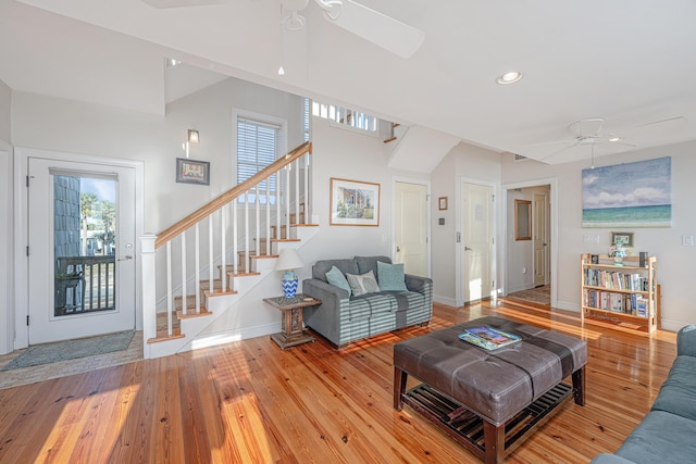 living room featuring light hardwood / wood-style floors, ceiling fan, and a healthy amount of sunlight