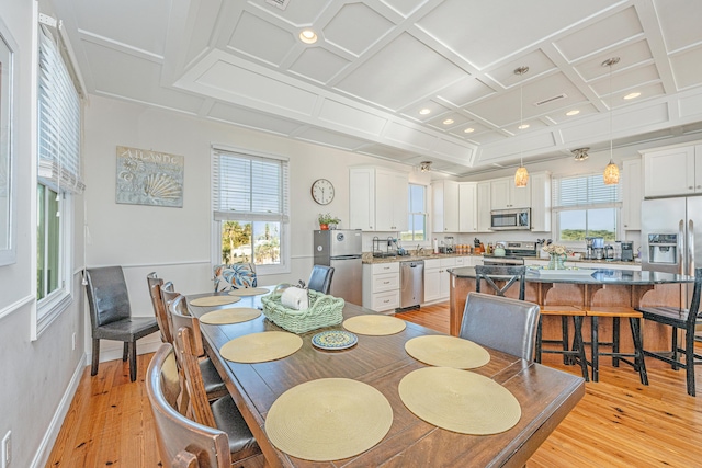 dining space featuring beam ceiling, a wealth of natural light, light hardwood / wood-style flooring, and coffered ceiling