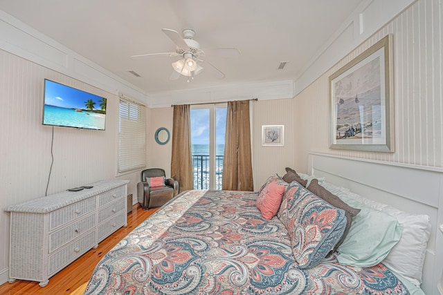 bedroom featuring access to outside, ceiling fan, and hardwood / wood-style flooring