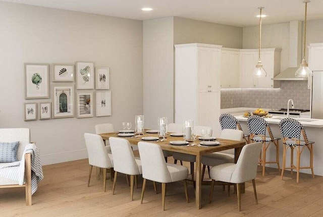 dining area featuring sink and light hardwood / wood-style floors