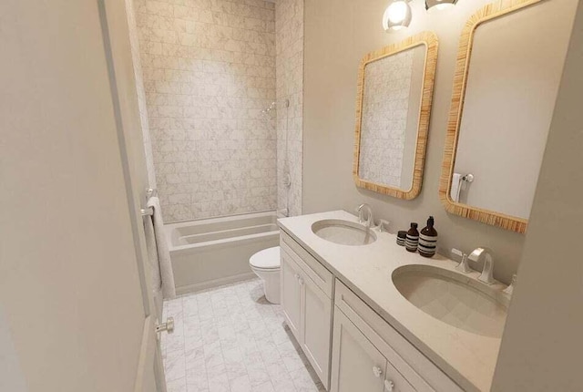 full bathroom with tiled shower / bath combo, vanity, and toilet