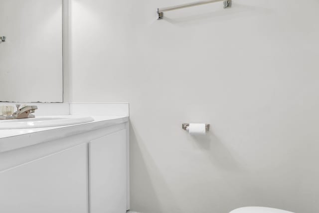 bathroom with toilet and vanity