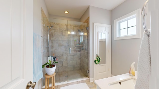 bathroom featuring sink and a shower with door