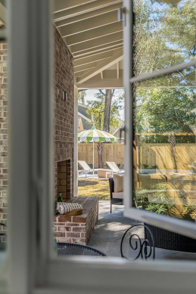 doorway featuring brick wall