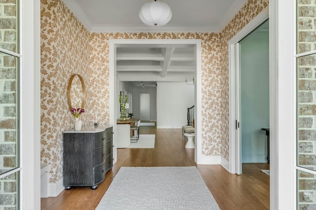 hallway featuring ornamental molding, coffered ceiling, hardwood / wood-style floors, and beam ceiling