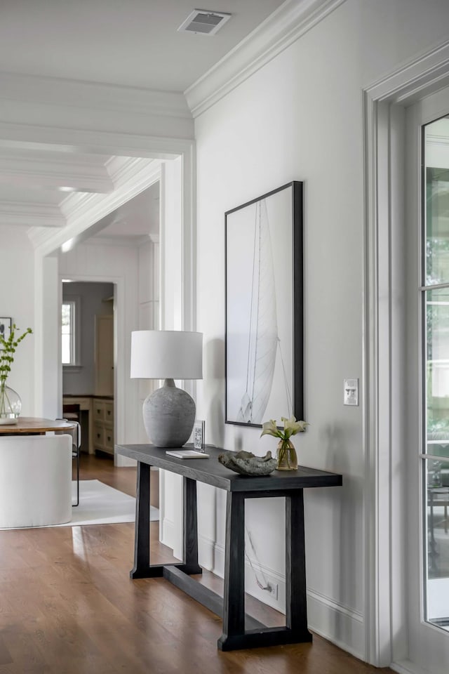 interior space with hardwood / wood-style flooring and ornamental molding