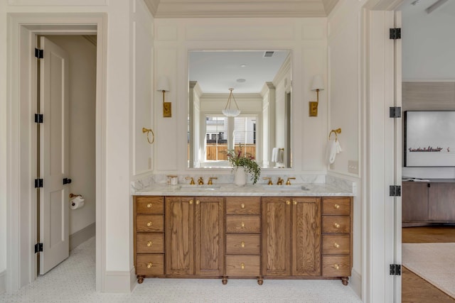 bathroom with ornamental molding and vanity