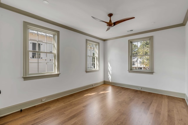 empty room with hardwood / wood-style floors, crown molding, and ceiling fan