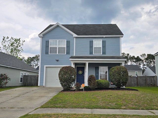 traditional-style house with concrete driveway, a front lawn, fence, and an attached garage