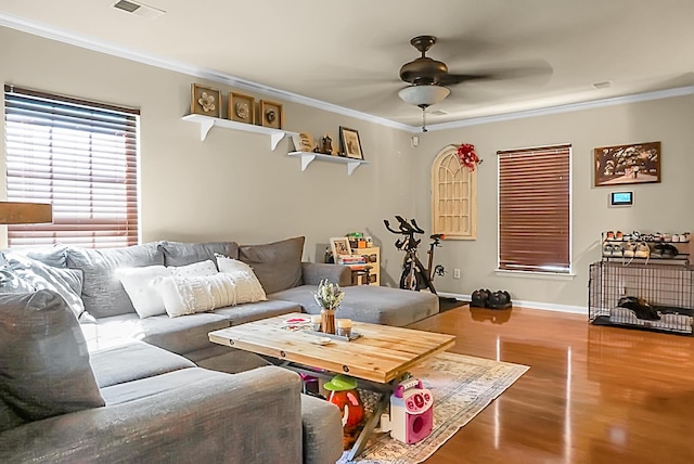 living room with wood finished floors, a ceiling fan, and ornamental molding